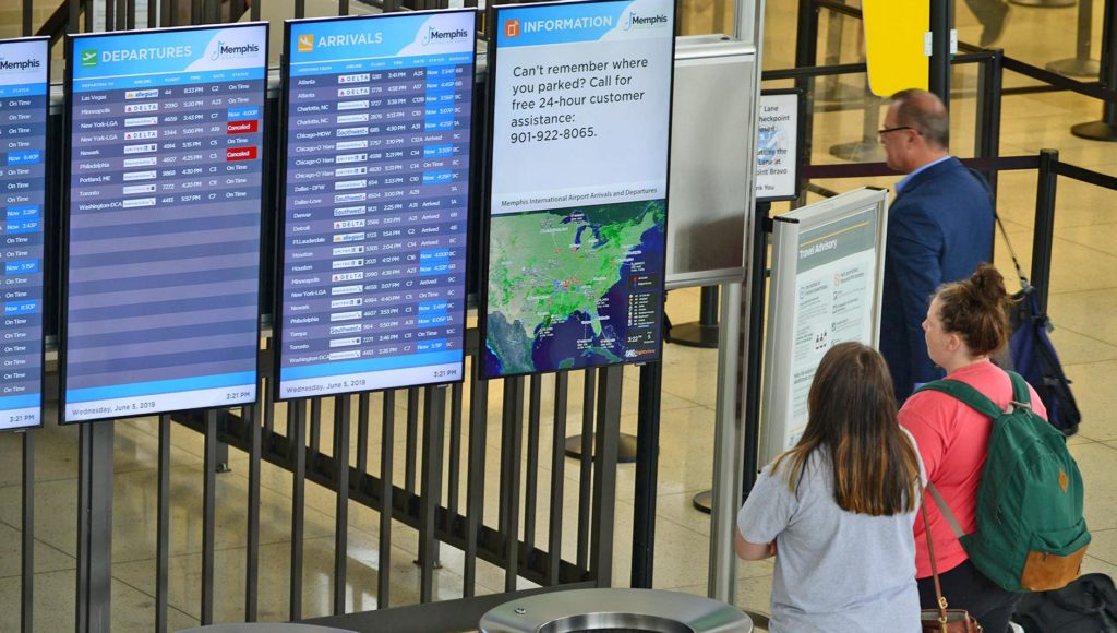 Passengers view FIDS in C ticketing